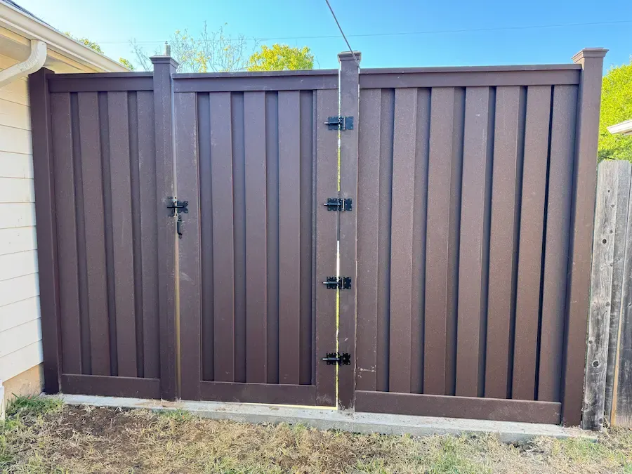 Brown double privacy gate with black hinges and latch hardware