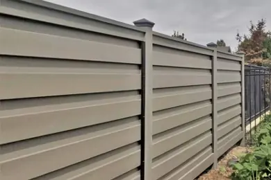 Gray horizontal-board privacy fence with matching posts and caps